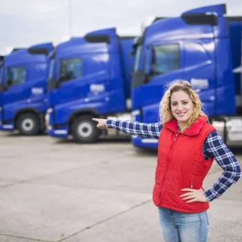 female-trucker-standing-front-parked-trucks-pointing-her-finger-transportation-vehicles